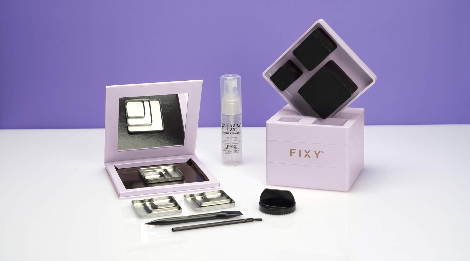 The FIXY Makeup Square Broken Makeup Repressing Kit including a makeup press, FIXY binding spray, grinder, tools, with empty magnetic palette and 10 pans