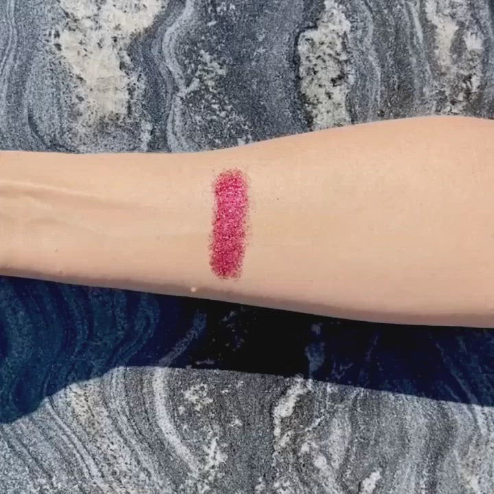 Red biodegradable loose glitter on skin