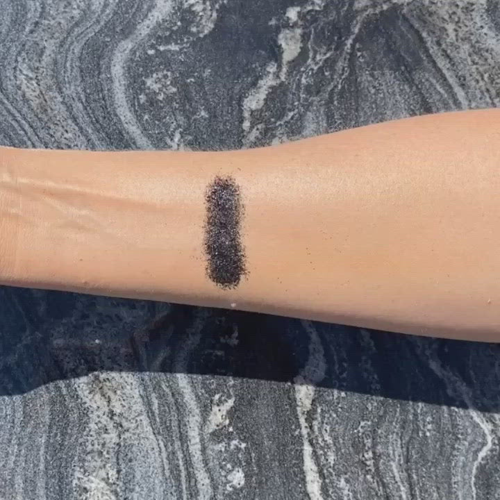 Black biodegradable loose glitter on skin